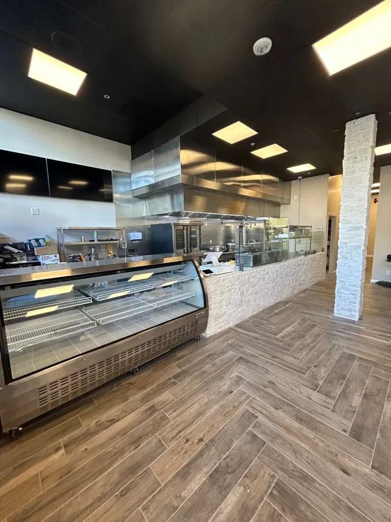 Completed commercial kitchen with CaptiveAire exhaust hood ready for service