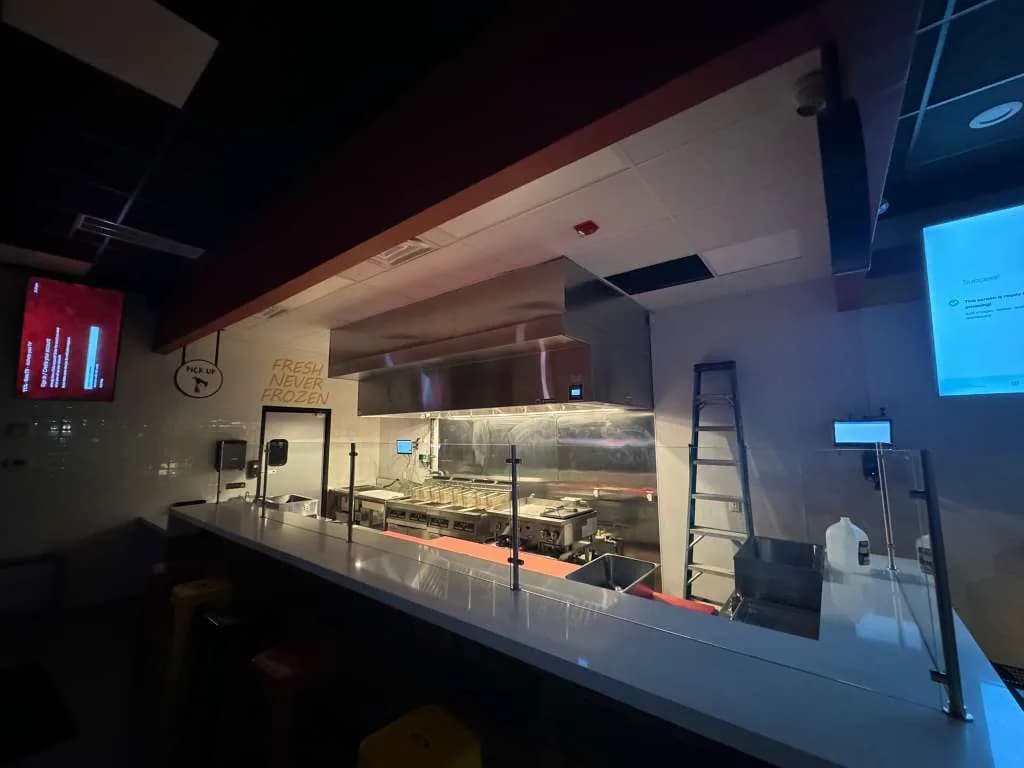 Finished fast-casual restaurant kitchen with CaptiveAire hood system