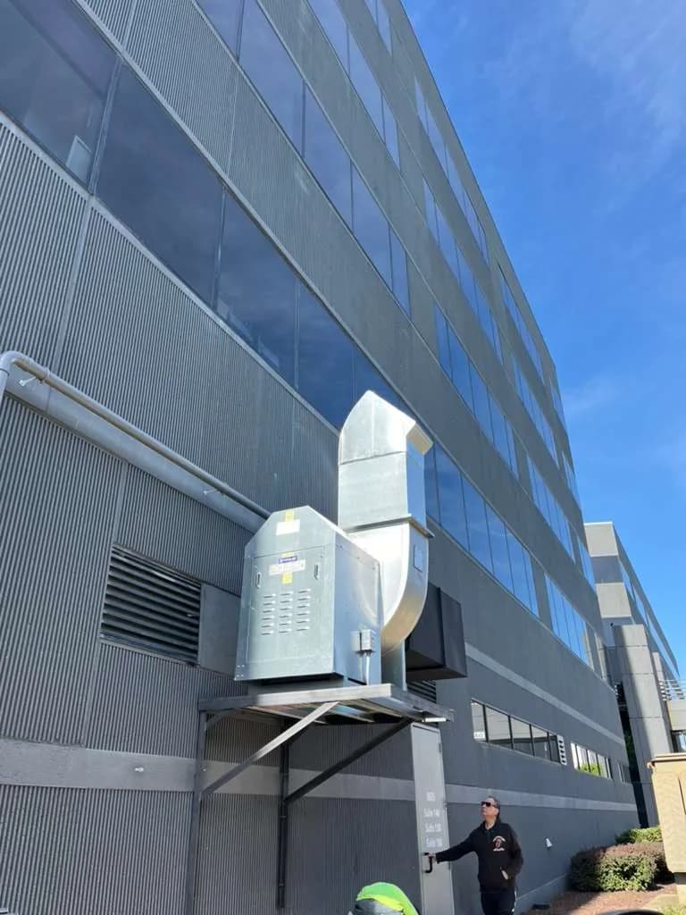 Wall-mounted commercial kitchen exhaust unit on Maryland office building