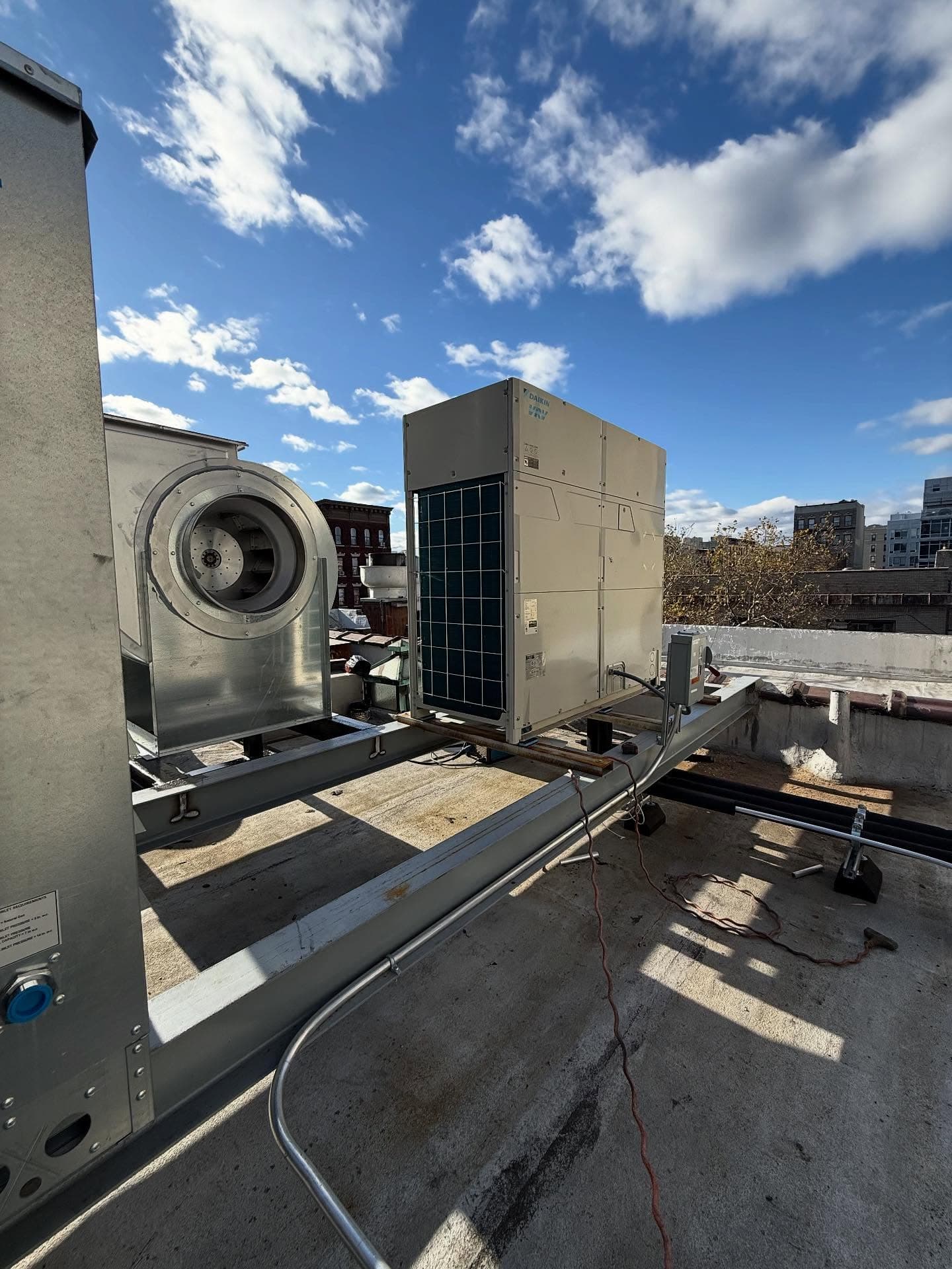 Rooftop commercial exhaust fan opened for maintenance and repair